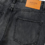 מכנס ג’ינס איינקר AINKER שחור דגם Brunel Black 1154 גזרה טייפרוד קרעים מינימליסטיים פאץ עור